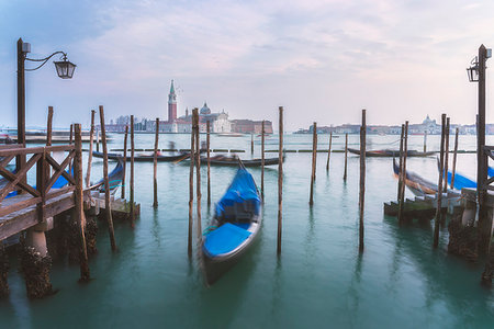 san giorgio maggiore - Gondolas tied up to wooden poles on the Canal Grande, in the background the monastery of San Giorgio Maggiore,Venice, Veneto, Italy Photographie de stock - Rights-Managed, Code: 879-09189229