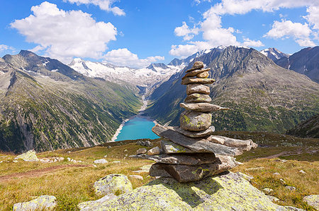 A cairn near Olperer refuge with Lake Schlegeispeicher on the background, Zillertal Alps, Tyrol, Schwaz district, Austria. Stock Photo - Rights-Managed, Code: 879-09189512