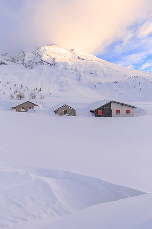 swiss alps sunset - Huts after heavy snowfall with the summit of Hübschhorn in the background. Simplon Pass, Canton of Valais/Wallis, Switzerland. Stock Photo - Rights-Managed, Code: 879-09189546