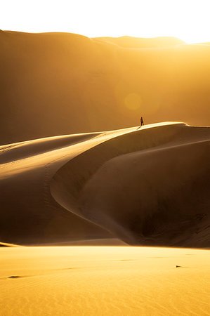 Lonely man in the desert at sunset,Walvis Bay,Namibia,Africa Photographie de stock - Rights-Managed, Code: 879-09189744