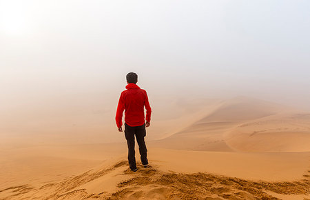 Man surrounded by fog in the desert dunes of Walvis Bay, Namibia, Africa Stock Photo - Rights-Managed, Code: 879-09189752