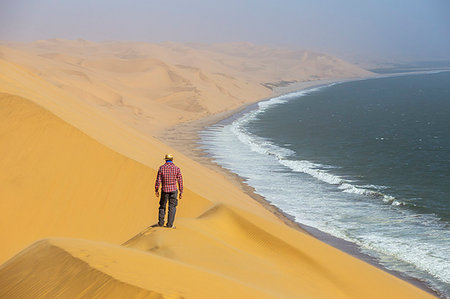 simsearch:879-09189743,k - Between desert and ocean a man admires the view,Sandwich Harbour,Namib Naukluft National Park,Namibia,Africa Stock Photo - Rights-Managed, Code: 879-09189762