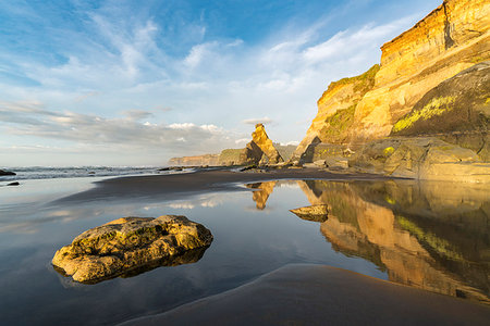 reflection not people not japan - Rock formations and cliff reflect with low tide. Tongaporutu, New Plymouth district. Taranaki region, North Island, New Zealand. Stock Photo - Rights-Managed, Code: 879-09189962