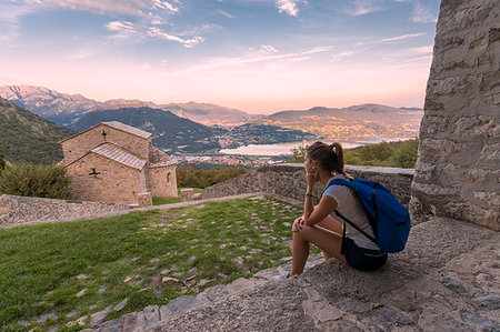Woman sightseeing at the abbey of San Pietro al Monte, an ancient monastic complex of Romanesque style in the town of Civate, Lecco province, Lombardy, italy Foto de stock - Con derechos protegidos, Código: 879-09190236