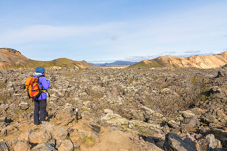 simsearch:879-09189960,k - A trekker is looking at the Landmannalaugar lava field (Landmannalaugar, Fjallabak Nature Reserve, Highlands, Southern Region, Iceland, Europe) (MR) Stock Photo - Rights-Managed, Code: 879-09190331