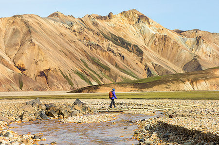 A trekker is walking to the Blahnukur mountain in Landmannalaugar (Fjallabak Nature Reserve, Highlands, Southern Region, Iceland, Europe) (MR) Stock Photo - Rights-Managed, Code: 879-09190333