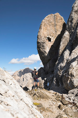 a hiker is looking at the military observatory along the via ferrata Bepi Zac on the battlefront of the World War One into the Marmolada Group, Trento Province, Trentino Alto Adige, Italy Stockbilder - Lizenzpflichtiges, Bildnummer: 879-09190540