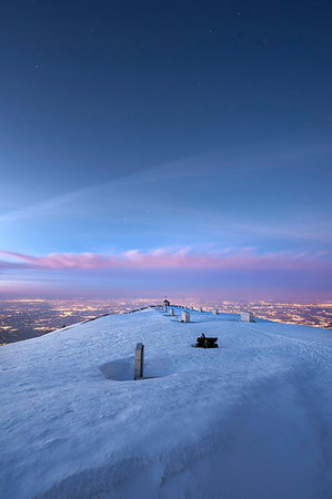 Monte Grappa, province of Vicenza, Veneto, Italy, Europe. On the summit of Monte Grappa there is a military memorial monument. In the background the lights of the Venetian Plain Fotografie stock - Rights-Managed, Codice: 879-09190659