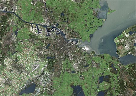 satellite view city - Amsterdam, Netherlands, True Colour Satellite Image. Amsterdam, Netherlands. True colour satellite image of Amsterdam, the capital city of the Netherlands. Image taken on 18 October 1999 using LANDSAT 7 data. Stock Photo - Rights-Managed, Code: 872-06052834