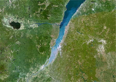 photographs quebec city - Saint-Lawrence River, Quebec, Canada, True Colour Satellite Image. Satellite image of Quebec city and the Saint-Lawrence river mouth, connection between the Atlantic ocean and the Great Lakes. Image taken on 23 August 2002 using LANDSAT data. Stock Photo - Rights-Managed, Code: 872-06052995