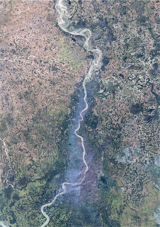 Pollution Cloud Over Calcutta (Kolkata), India, True Colour Satellite Image. Calcutta (Kolkata), India, true colour satellite image. A pollution cloud spreads linearly along the banks of the river Hooghly and stagnates over the city of Calcutta (Kolkata). Image taken on 15 November 1999 using LANDSAT data. Stock Photo - Rights-Managed, Code: 872-06053032