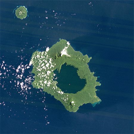 Long Island Volcano, Papua New Guinea, True Colour Satellite Image. Long Island volcano, Papua New Guinea, true colour satellite image. Long Island volcano is in the Bismark Sea, in Papua New Guinea. This volcano contains a large caldera filled by Lake Wisdom. Image taken on 31 March 1991 using LANDSAT data. Print size 30 x 30 cm. Stock Photo - Rights-Managed, Code: 872-06053079