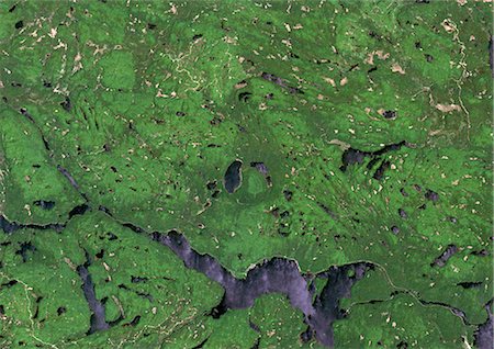 Brent Meteor Impact Crater, Ontario, Canada, True Colour Satellite Image. True colour satellite image of Brent impact structure, Ontario, Canada (diameter : 3,8 km). Image taken on 1 June 1991 using LANDSAT data. Stock Photo - Rights-Managed, Code: 872-06053115