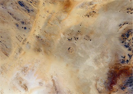 simsearch:872-06053083,k - Meteor Impact Crater, Libya, True Colour Satellite Image. True colour satellite image of an impact structure North of Koufra Oasis (24 06'N - 23 24'E), in the Libyan desert. Image taken on 9 November 1986 using LANDSAT data. Stock Photo - Rights-Managed, Code: 872-06053130