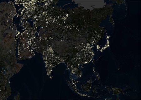 satellite view - Asia At Night, True Colour Satellite Image. True colour satellite image of Asia at night. This image in Lambert Azimuthal Equal Area projection was compiled from data acquired by LANDSAT 5 & 7 satellites. Stock Photo - Rights-Managed, Code: 872-06053634