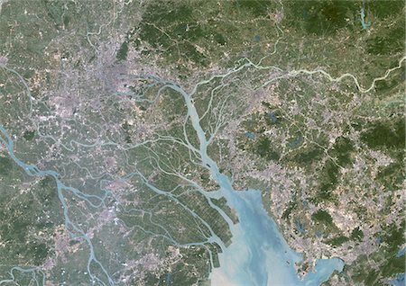 satellite view city - Canton And Shenzen, China, In 2000, True Colour Satellite Image. True colour satellite image of the cities of Guangzhou (Canton) and Shenzen, China. Image in landscape format, taken on 14 September 2000, using LANDSAT data. Stock Photo - Rights-Managed, Code: 872-06053807
