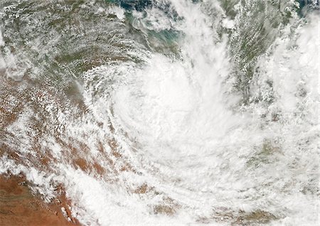 satellite view storm - Cyclone Larry, Australia, In 2006, True Colour Satellite Image. Tropical Cyclone Larry over the Coral Sea off the coast of Queensland, Australia, on 21 March 2006. True-colour satellite image using MODIS data. Stock Photo - Rights-Managed, Code: 872-06053827