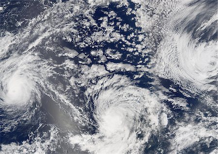 Hurricanes Kenneth, Jova And Max, Pacific Ocean, In 2005, True Colour Satellite Image. Satellite image of Hurricane Jova (left), Kenneth (center), and Tropical Storm Max (right) on 21 September 2005 over the Pacific ocean, off the coast of Baja California, Mexico. True-colour satellite image using MODIS data. Foto de stock - Con derechos protegidos, Código: 872-06053854