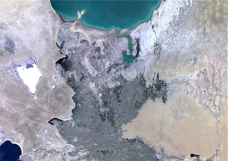 simsearch:872-06053522,k - Amu Darya Delta, Uzbekistan, True Colour Satellite Image. True colour satellite image of Amu Darya Delta in Uzbekistan. The Amu Darya River flows into the Aral Sea. Composite image using LANDSAT 5 data. Stock Photo - Rights-Managed, Code: 872-06053916