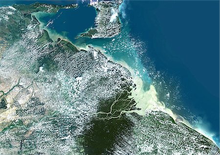 delta - Wahre Farbe-Satellitenbild von Orinoco Delta in Venezuela. Echtfarben-Satellitenbild des Orinoco-Delta im östlichen Venezuela, der Orinoco Fluss mündet in den Atlantischen Ozean. Oben steht die Insel Trinidad in der Karibik. Composite-Bild LANDSAT 5 Daten. Stockbilder - Lizenzpflichtiges, Bildnummer: 872-06053913