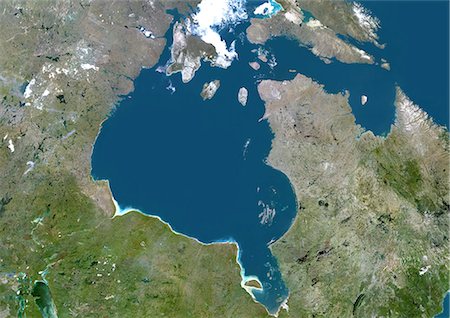 Hudson Bay, Canada, True Colour Satellite Image. True colour satellite image of Hudson Bay, a large body of water in northeastern Canada. A smaller offshoot of the bay, James Bay, lies to the south. North of Hudson Bay is Southampton island and westnorth is Baffin island. One group of islands in the southeast of the bay is the Belcher Islands. Composite image using LANDSAT 5 data. Foto de stock - Con derechos protegidos, Código: 872-06053940