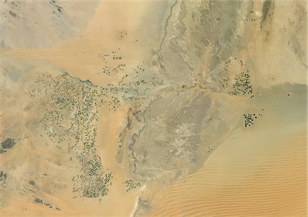 simsearch:872-06052792,k - Agriculture In The Desert, South Part Of The Riyadh Province, Saudi Arabia, True Colour Satellite Image. True colour satellite image of agriculture in the desert in Saudi Arabia. The image shows the south part of the Riyadh Province, about 500 km south of Riyadh. Circular agricultural plots are visible on the image. Composite image from 2001, using LANDSAT 7 data. Stock Photo - Rights-Managed, Code: 872-06053958