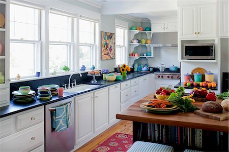 White kitchen filled with colorful plates and food, Cape Elizabeth, ME, Annie Stickney Design. Stock Photo - Rights-Managed, Code: 872-08914929