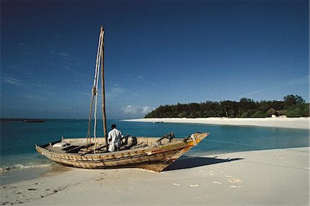 Fisherman in Boat on Beach Zanzibar, Tanzania Stock Photo - Rights-Managed, Code: 873-06440435