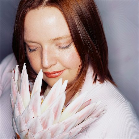 stop to smell the flowers - Woman Holding Pink Protea Flower Stock Photo - Rights-Managed, Code: 873-06440866