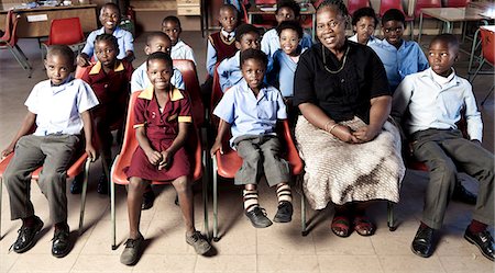 simsearch:6110-06702683,k - African female teacher sitting with her students, smiling at camera Stock Photo - Rights-Managed, Code: 873-06675248