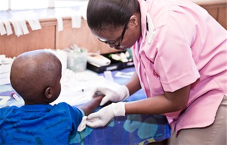 Nurse helping young African boy Stock Photo - Rights-Managed, Code: 873-06675604