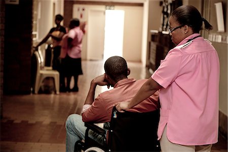 Nurse pushing African man in a wheelchair Stock Photo - Rights-Managed, Code: 873-06675614