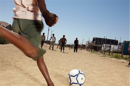 Kicking soccer ball in a dusty street, Vredenburg, Western Cape Province Stock Photo - Rights-Managed, Code: 873-07156751