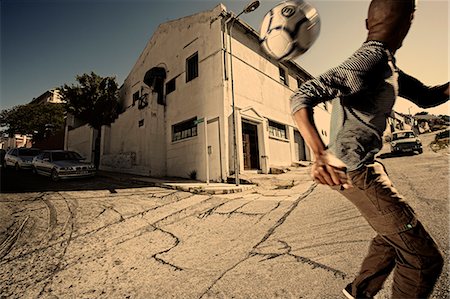 Boy playing soccer on the street Foto de stock - Con derechos protegidos, Código: 873-07156762