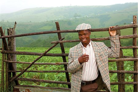 simsearch:873-07156817,k - Young Xhosa man in front of a gate Stock Photo - Rights-Managed, Code: 873-07156819